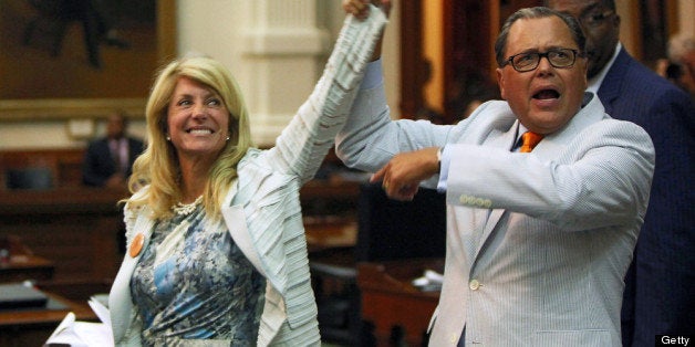 AUSTIN, TX - JUNE 25: State Sen. Jose Rodriguez (D-El Paso) (R) celebrates with State Sen. Wendy Davis (D-Ft. Worth) (3L) as