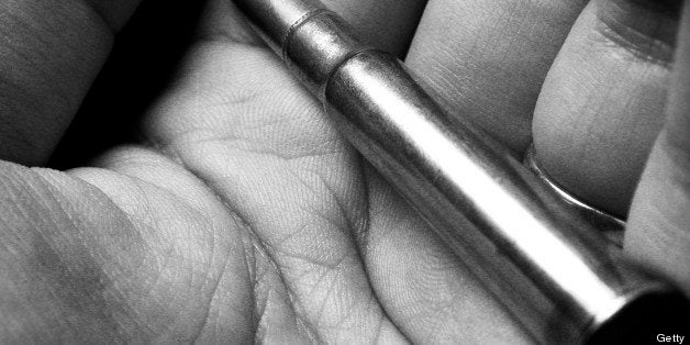 Hand holding bullet
