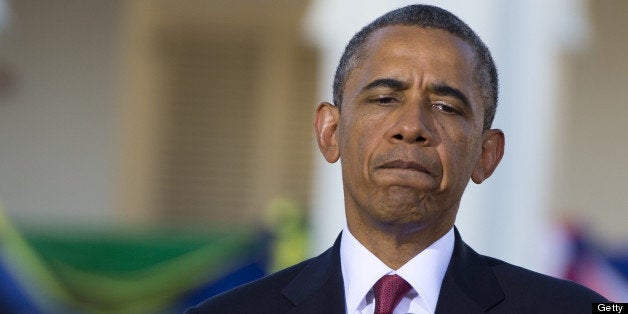 US President Barack Obama reacts during a joint press conference following meetings with Tanzanian President at the State Hou