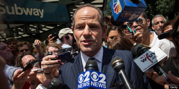 NEW YORK, NY - JULY 08: Former New York Gov. Eliot Spitzer is mobbed by reporters while attempting to collect signatures to run for comptroller of New York City on July 8, 2013 in New York City. Spitzer resigned as governor in 2008 after it was discovered that he was using a high end call girl service. (Photo by Andrew Burton/Getty Images)