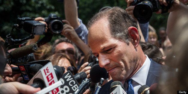 NEW YORK, NY - JULY 08: Former New York Gov. Eliot Spitzer is mobbed by reporters while attempting to collect signatures to run for comptroller of New York City on July 8, 2013 in New York City. Spitzer resigned as governor in 2008 after it was discovered that he was using a high end call girl service. (Photo by Andrew Burton/Getty Images)
