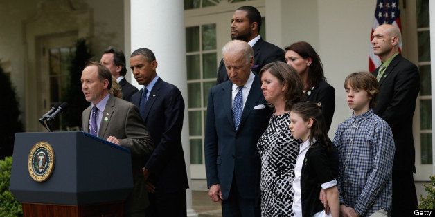 WASHINGTON, DC - APRIL 17: Father of Sandy Hook Elementary School shooting victim, Mark Barden (L) introduces U.S. President Barack Obama (3L) as U.S. Vice President Joe Biden (4L) and family members of Newtown, CT shooting victims look on in the Rose Garden of the White House on April 17, 2013 in Washington, DC. Earlier today the Senate defeated a bi-partisan measure to expand background checks for gun sales. (Photo by Win McNamee/Getty Images)
