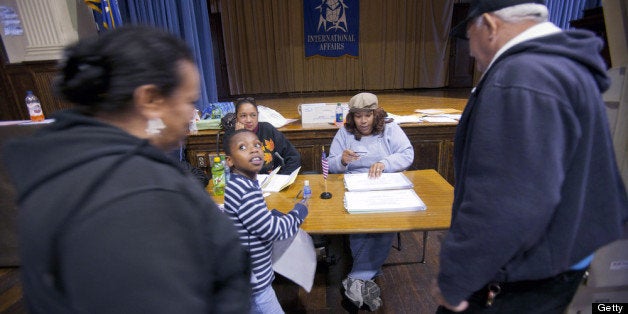 PHILADELPHIA, PA - APRIL 24: Voters show identification as they sign in to vote during the Republican primary election April 24, 2012 at Bodine High School in Philadelphia, Pennsylvania. Turnout is expected to be low as Former Massachusetts Gov. Mitt Romney continues his campaign as the presumptive GOP candidate. (Photo by Jessica Kourkounis/Getty Images)