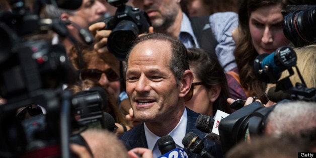 NEW YORK, NY - JULY 08: Former New York Gov. Eliot Spitzer is mobbed by reporters while attempting to collect signatures to