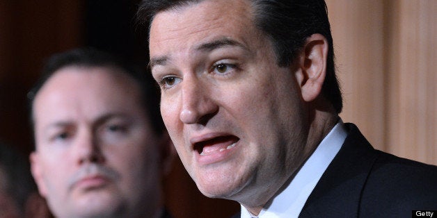 US Senator Ted Cruz R-TX, speaks as Senator Mike Lee, R-Utah, looks on during a press conference on defunding 'Obamacare' on