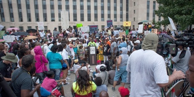 Supporters of Trayvon Martin rally at the E. Barrett Prettyman Federal Courthouse in Washington, D.C., to press the federal government to investigate civil rights charges against George Zimmerman, Saturday, July 20, 2013. The National Action Network has organized simultaneous rallies in more than 100 cities. (Andre Chung/MCT via Getty Images)