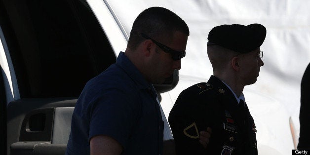 FORT MEADE, MD - JULY 30: U.S. Army Private First Class Bradley Manning (R) is escorted by military police as arrives to hear the verdict in his military trial July 30, 2013 at Fort George G. Meade, Maryland. Manning, who is charged with aiding the enemy and wrongfully causing intelligence to be published on the internet, is accused of sending hundreds of thousands of classified Iraq and Afghanistan war logs and more than 250,000 diplomatic cables to the website WikiLeaks while he was working as an intelligence analyst in Baghdad in 2009 and 2010. (Photo by Mark Wilson/Getty Images)