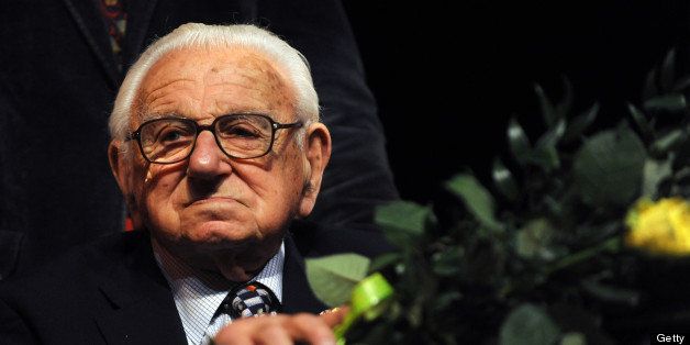 Sir Nicholas Winton, who arranged for the children to be hosted by British families and negotiated their departure with the occupying Nazi Germans between March and September 1939, holds flowers as he attends the premiere of 'Nicky's Family', on January 20, 2011, in Prague. Winton has been called the 'English Schindler,' in reference to Oskar Schindler, whose rescue of hundreds of Jews in wartime Poland was immortalised in Steven Spielberg's film 'Schindler's List.' Winton's story only came to light by chance 50 years later when his wife found papers relating to it in a battered briefcase in his attic. AFP PHOTO / MICHAL CIZEK (Photo credit should read MICHAL CIZEK/AFP/Getty Images)