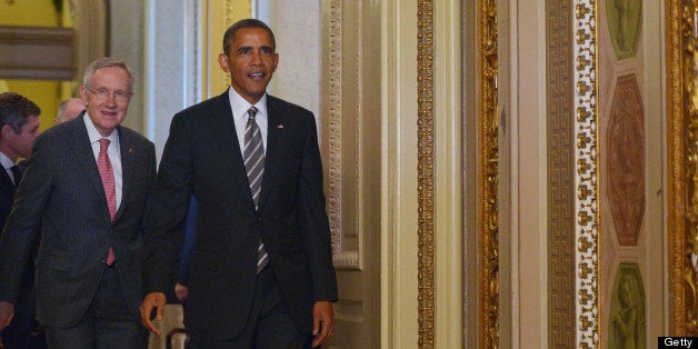 US President Barack Obama(R) and Senate Majority Leader Harry Reid, D-NV, arrive for a meeting with the Senate Democratic Caucus on July 31, 2013 in the US Capitol in Washington, DC. AFP PHOTO/Mandel NGAN (Photo credit should read MANDEL NGAN/AFP/Getty Images)