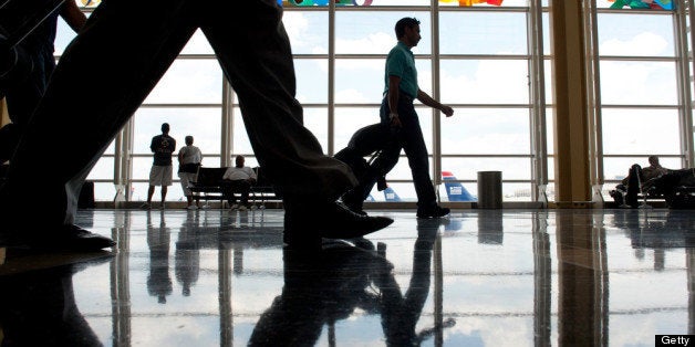ARLINGTON, VA - AUGUST 2: Travelers walk through the concourse of Ronald Reagan Washington National Airport in Arlington, VA