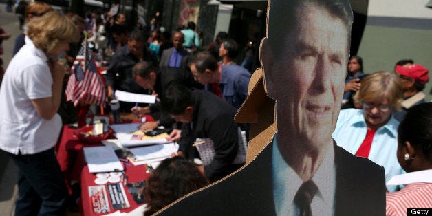 OAKLAND, CA - JULY 30: A cardboard cutout of former U.S. President Ronald Reagan is displayed as newly sworn in U.S. citizens register to vote following a naturalization ceremony at the Paramount Theatre on July 30, 2013 in Oakland, California. Over 1,100 immigrants became U.S. citizens at the naturalization ceremony. (Photo by Justin Sullivan/Getty Images)