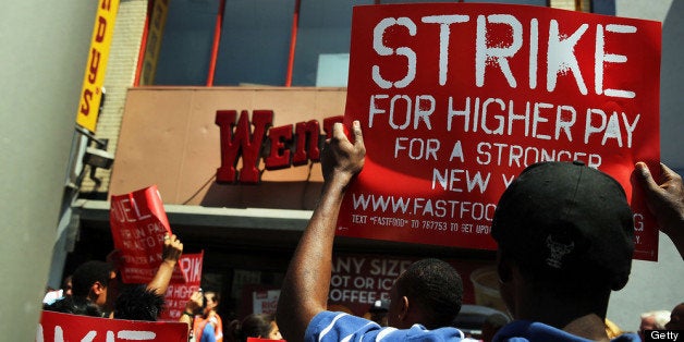 NEW YORK, NY - JULY 29: Employees and supporters demonstrate outside of a Wendy's fast-food restaurant to demand higher pay and the right to form a union on July 29, 2013 in New York City. Across the country thousands of low-wage workers are expected to walk off their jobs Monday at fast food establishments in seven U.S. cities. Workers at KFC, Wendy's, Burger King, McDonald's and other restaurants are calling for a living wage of $15 an hour and the right to form a union without retaliation. (Photo by Spencer Platt/Getty Images)