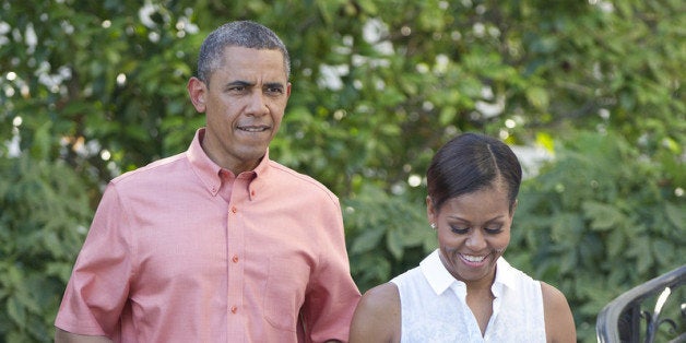 WASHINGTON, DC - JULY 04: U.S. President Barack Obama and first lady Michelle Obama walk down the South Portico stairs to work the rope line as they host a Fourth of July barbecue for military heroes and their families on the South Lawn of the White House on July 4, 2013 in Washington, DC. The president and first lady are hosting members of the military and their families in commemoration of Independence Day. (Photo by Ron Sachs-Pool/Getty Images)