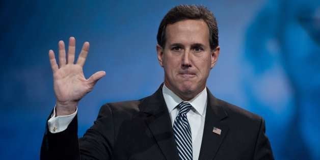 Former US Republican Senator from Pennsylvania Rick Santorum waves after speaking at the Conservative Political Action Confer