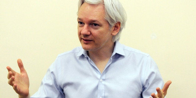 EMBARGOED UNTIL 0001GMT ON WEDNESDAY, JUNE 19, 2013 Wikileaks founder Julian Assange speaks to the media inside the Ecuadorian Embassy in London on June 14, 2013, ahead of the first anniversary of his arrival there on June 19, 2012. A year after seeking refuge at the Ecuadorian embassy in London, Julian Assange remains fearful of US 'revenge' over the WikiLeaks disclosures and aware that the diplomatic deadlock over his case may continue for months, if not years. AFP PHOTO/POOL/ANTHONY DEVLIN (Photo credit should read Anthony Devlin/AFP/Getty Images)