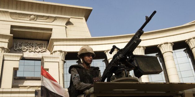 An Egyptian soldier is seen manning an armoured personnel carrier (APC) outside the Egyptian Constitutional Court in Cairo on August 19, 2013, while militants elsewhere killed 25 policemen in the deadliest attack of its kind in years, as Egypt's army-installed rulers escalated a campaign to crush supporters of ousted president Mohamed Morsi's Muslim Brotherhood. The assailants fired rocket-propelled grenades at two buses carrying police in the Sinai Peninsula, sources said, just hours after 37 Brotherhood prisoners died in police custody. AFP PHOTO/KHALED DESOUKI (Photo credit should read KHALED DESOUKI/AFP/Getty Images)