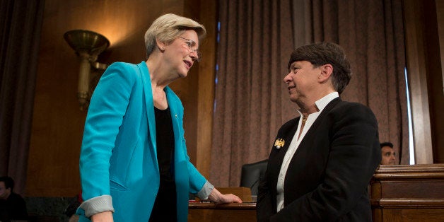 Mary Jo White, chairman of the U.S. Securities and Exchange Commission (SEC), left, talks to Senator Elizabeth Warren, a Democrat from Massachusetts, before the start of a Senate Banking Committee hearing in Washington, D.C., U.S., on Tuesday, July 30, 2013. U.S. banks' ownership and trading of physical commodities faced further scrutiny today when the heads of the Commodity Futures Trading Commission and SEC testified before lawmakers. Photographer: Andrew Harrer/Bloomberg via Getty Images 