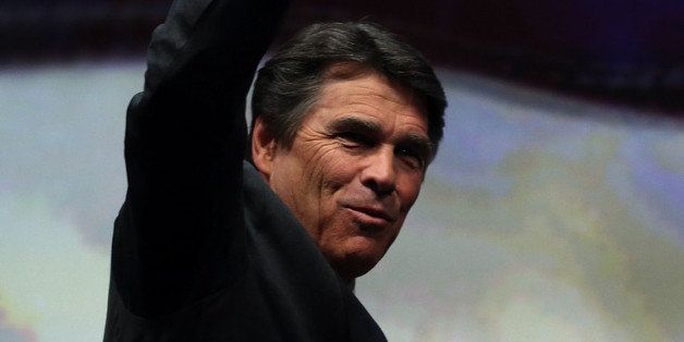 HOUSTON, TX - MAY 03: Texas Gov. Rick Perry pumps his fist before speaking during the 2013 NRA Annual Meeting and Exhibits at the George R. Brown Convention Center on May 3, 2013 in Houston, Texas. More than 70,000 peope are expected to attend the NRA's 3-day annual meeting that features nearly 550 exhibitors, gun trade show and a political rally. The Show runs from May 3-5. (Photo by Justin Sullivan/Getty Images)
