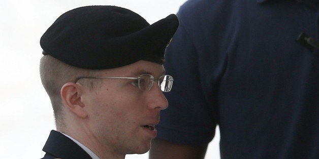 FORT MEADE, MD - AUGUST 21: US Army Private First Class Bradley Manning is escorted by military police as he arrives for his