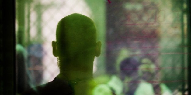 This image reviewed by the US military shows a guard standing watch behind a one way mirror in cell block A in the 'Camp Six' detention facility of the Joint Detention Group at the US Naval Station in Guantanamo Bay, Cuba, January 19, 2012. AFP PHOTO/Jim WATSON (Photo credit should read JIM WATSON/AFP/Getty Images)