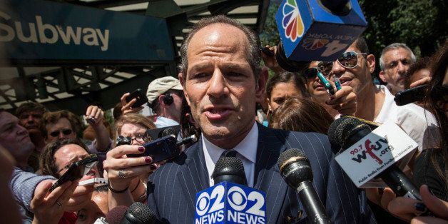 NEW YORK, NY - JULY 08: Former New York Gov. Eliot Spitzer is mobbed by reporters while attempting to collect signatures to run for comptroller of New York City on July 8, 2013 in New York City. Spitzer resigned as governor in 2008 after it was discovered that he was using a high end call girl service. (Photo by Andrew Burton/Getty Images)