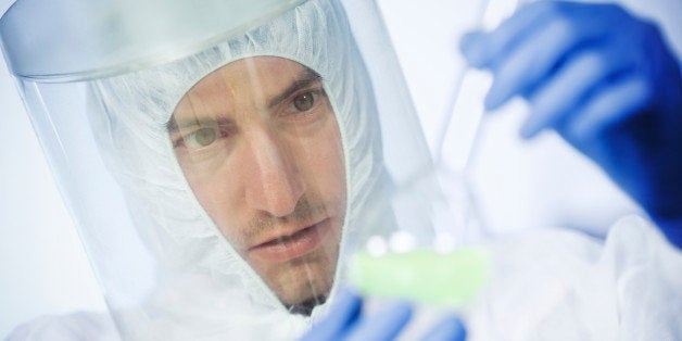 scientists working at the laboratory examining hazardous chemicals. close up