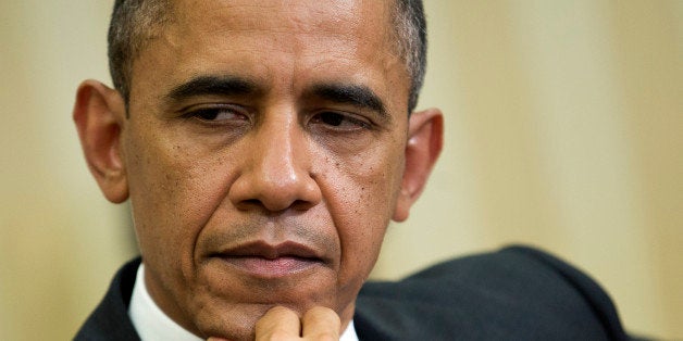 U.S. President Barack Obama listens during a meeting with Hamad bin Khalifa al-Thani, the Amir of Qatar, unseen, in the Oval Office of the White House on Tuesday, April 23, 2013. Obama met with the emir of Qatar as the two nations consider different approaches toward toppling Syria?s leader and share concerns about Iran?s nuclear ambition. Photographer: Joshua Roberts/Bloomberg via Getty Images