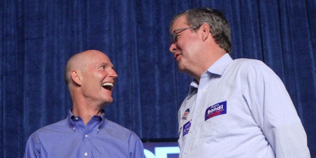 Republican gubernatorial nominee Rick Scott laughs with former Florida governor Jeb Bush during an airport rally in Orlando, Florida, Saturday, October 30, 2010. Scott is blitzing the state with stops in Orlando, Jacksonville, Winter Park, Hialeah, and Tampa, Saturday. (Photo by Joe Burbank/Orlando Sentinel/MCT via Getty Images)