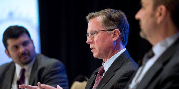 Barry Smitherman, chairman of the Texas Railroad Commission, center, speaks during a panel discussion at the 2013 IHS CERAWee