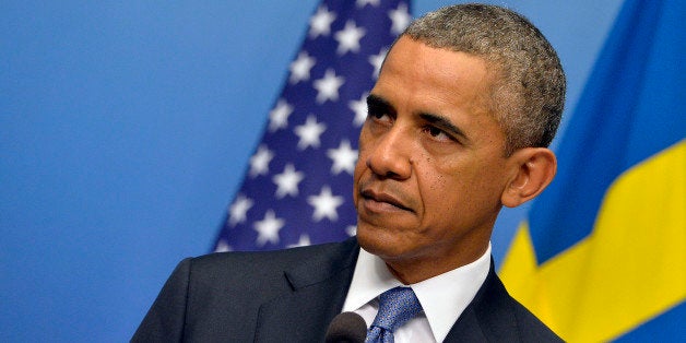 US President Barack Obama listens to a question on Syria during a joint press conference with Swedish Prime Minister after their bilateral meeting at the Rosenbad Building in Stockholm on September 4, 2013. Obama met with Fredrik Reinfeldt upon arrival in Sweden on a two-day official trip before leaving for Russia, where he will attend G20 summit. Russia on Thursday hosts the G20 summit hoping to push forward an agenda to stimulate growth but with world leaders distracted by divisions on the prospect of US-led military action in Syria. AFP PHOTO / JEWEL SAMAD (Photo credit should read JEWEL SAMAD/AFP/Getty Images)
