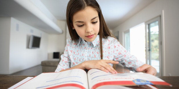 Girl (10-12) doing homework