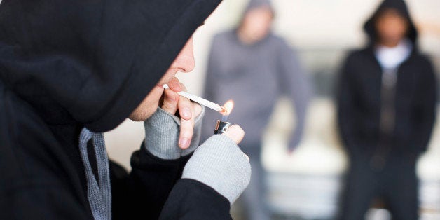 Man lighting marijuana cigarette