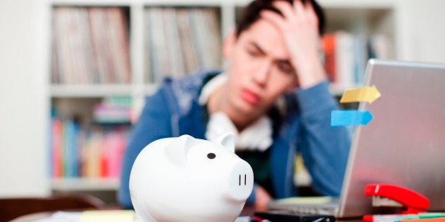 Piggy bank with young man worrying in background