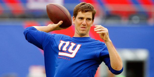 EAST RUTHERFORD, NJ - SEPTEMBER 15: (NEW YORK DAILIES OUT) Eli Manning #10 of the New York Giants warms up before a game against the Denver Broncos on September 15, 2013 at MetLife Stadium in East Rutherford, New Jersey. The Broncos defeated the Giants 41-23. (Photo by Jim McIsaac/Getty Images) 