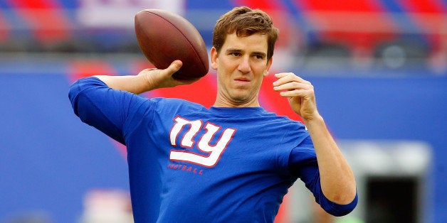 EAST RUTHERFORD, NJ - SEPTEMBER 15: (NEW YORK DAILIES OUT) Eli Manning #10 of the New York Giants warms up before a game against the Denver Broncos on September 15, 2013 at MetLife Stadium in East Rutherford, New Jersey. The Broncos defeated the Giants 41-23. (Photo by Jim McIsaac/Getty Images)