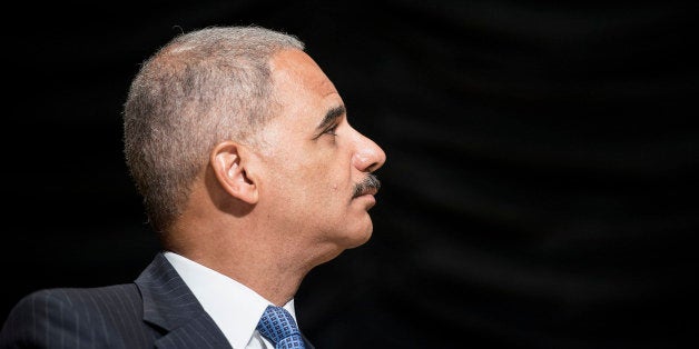 US Attorney General Eric Holder listens during a farewell ceremony during a farewell ceremony for Homeland Security Secretary Janet Napolitano at the Ronald Reagan Building September 6, 2013 in Washington, DC. Napolitano is leaving her post to become president of the University of California system. AFP PHOTO/Brendan SMIALOWSKI (Photo credit should read BRENDAN SMIALOWSKI/AFP/Getty Images)