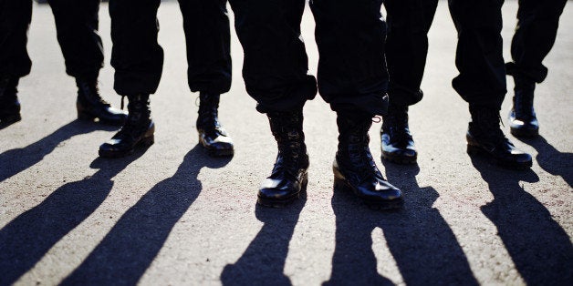 Men in SWAT team gear and shadows, low section