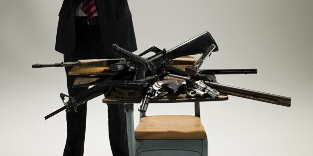 Man with guns on a desk