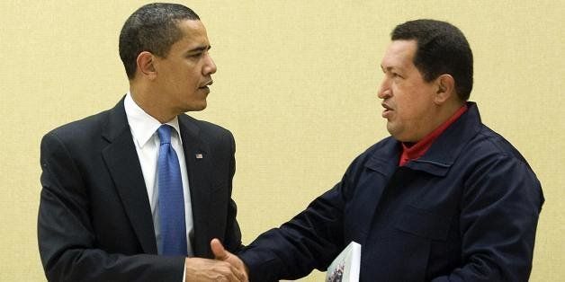 Venezuelan President Hugo Chavez (R) gives a book, 'The Open Viens of Latin America' of Uruguayan writer Eduardo Galeano to US President Barack Obama (L) during a multilateral meeting to begin during the Summit of the Americas at the Hyatt Regency in Port of Spain, Trinidad April 18, 2009. AFP PHOTO/Jim WATSON (Photo credit should read JIM WATSON/AFP/Getty Images)
