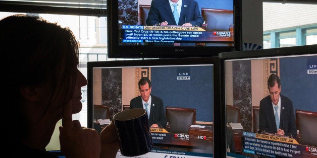 A journalist watches C-SPAN TV on computer screens showing US Senator Ted Cruz (R-TX) on September 25, 2013 in Washington,DC. Most US senators expect to pass a stopgap spending bill this week, but one lawmaker is so against it he took to the Senate floor -- for 19 hours and counting. Few knew that Senator Ted Cruz would still be engaged in his talkathon, much less even awake, on Wednesday morning to oppose the temporary budget. But such is his fierce opposition to President Barack Obama's signature health care law, whose funding is part of the bill, that he held the Senate floor through the night, delivering one of the longest Senate speeches since precise record-keeping began in 1900. The conservative first-term lawmaker was voicing what he said is America's deep discontent for the law known as 'Obamacare,' and aimed to unite Republicans in opposition to passing a spending bill that does not defund the health care law. AFP PHOTO/MLADEN ANTONOV (Photo credit should read MLADEN ANTONOV/AFP/Getty Images)