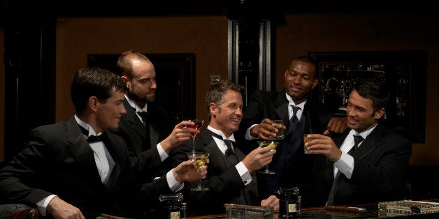 Men in dinner jackets drinking cocktails in bar