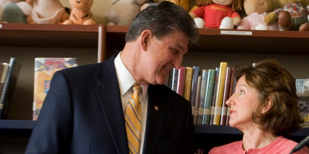 UNITED STATES - MARCH 2: Sen. Joe Manchin, D-W.V., has a word with Sen. Kay Hagan, D-N.C., as Sen. Tom Carper, D-Del., speaks at a news conference at Walker-Jones Education Campus, a K-8 school on New Jersey Avenue, NW, to outline specific goals for education reform in the 112th Congress. (Photo By Tom Williams/Roll Call)