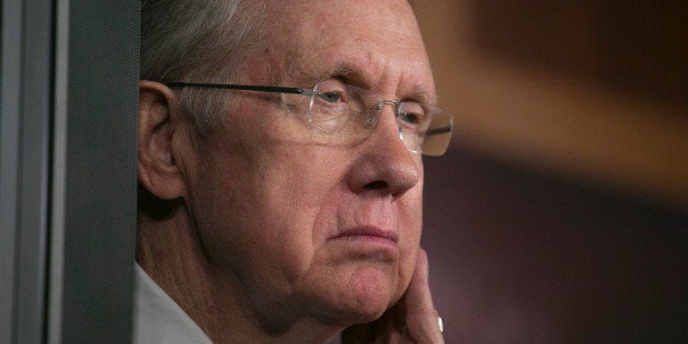 Senator Harry Reid, a Democrat from Nevada and Senate majority leader, listens during a news conference in Washington, D.C., U.S., on Thursday, Sept. 26, 2013. The Senate is accelerating debate on a bill that would avert a U.S. government shutdown as Senate Republicans sought to buy time for their House counterparts to take another swipe at President Barack Obama's health-care law. Photographer: Andrew Harrer/Bloomberg via Getty Images