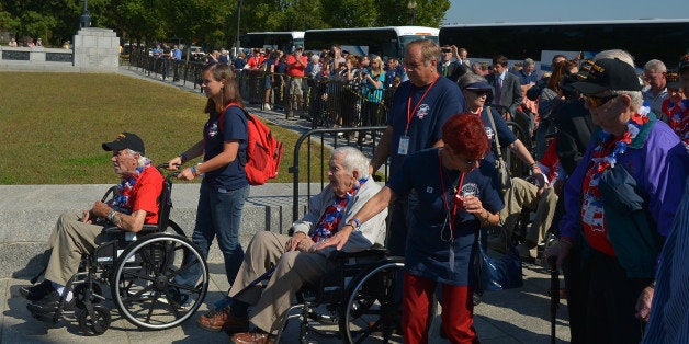 WASHINGTON, DC - OCTOBER 1: World War II Veterans and members of the Mississippi Gulf Coast Honor Flight ascend on the World War II Memorial after the barricades were opened up on October 1, 2013 in Washington, D.C. Members of the Mississippi Gulf Coast Honor Flight and members of the Story County Freedom Flight of Ames, Iowa, visited the World War II Memorial on the first day of the Federal Government shutdown. The groups were granted access to the closed memorial after arriving by busloads. (Photo by Ricky Carioti/The Washington Post via Getty Images)