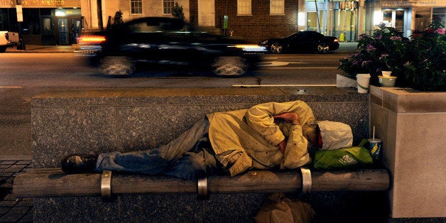 WASHINGTON, DC - SEPTEMBER 26: A homeless man sleeps just yards from a doorway at the International Monetary Fund building where John McDermott slept for over a year. John McDermott is a former cook at the White House who ended up on the streets. He's been helped with an apartment via a program that has steadily lost funding under Mayor Gray. (Photo by Michael S. Williamson/The Washington Post via Getty Images)