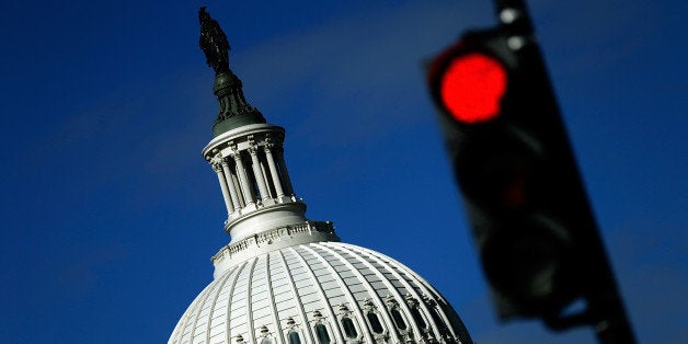 WASHINGTON, DC - SEPTEMBER 29: A traffic light is seen in front of the United States Capitol building as Congress remains gr