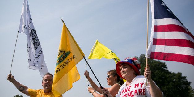 WASHINGTON, DC - SEPTEMBER 10: Tea Party activists wave flags during a 'Exempt America from Obamacare' rally, on Capitol Hill, September 10, 2013 in Washington, DC. Some conservative lawmakers are making a push to try to defund the health care law as part of the debates over the budget and funding the federal government. (Photo by Drew Angerer/Getty Images)
