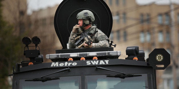 WATERTOWN, MA - APRIL 19: Members of a police S.W.A.T. team search through a neighborhood in Watertown as they search for 19-year-old bombing suspect Dzhokhar A. Tsarnaev on April 19, 2013 in Watertown, Massachusetts. After a car chase and shoot out with police, one suspect in the Boston Marathon bombing, Tamerlan Tsarnaev, 26, was shot and killed by police early morning April 19, and a manhunt is underway for his brother and second suspect, 19-year-old Dzhokhar A. Tsarnaev. The two men are suspects in the bombings at the Boston Marathon on April 15, that killed three people and wounded at least 170. (Photo by Spencer Platt/Getty Images)