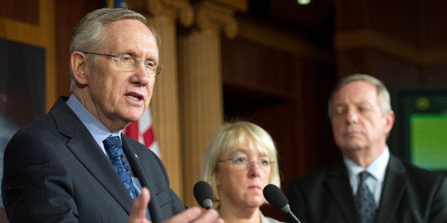 Senate Majority Leader Harry Reid, D-Nevada (L) speaks with US senators Patty Murray (C), D-Washington and Dick Durbin, D-Illinios, during a press conference on Capitol Hill about the debt ceiling in Washington, DC, October 12, 2013. AFP PHOTO / Jim WATSON (Photo credit should read JIM WATSON/AFP/Getty Images)