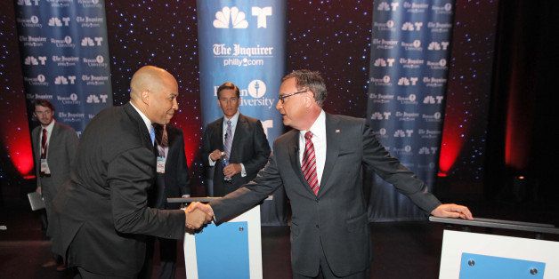 GLASSBORO, NJ - OCTOBER 9: U.S. Senate candidates Cory Booker (left) and Steve Lonegan shake hands before their second televised debate moderatred by Tim Rosenfield (center), NBC 10, at Pfleeger Concert Hall, Wilson Hall, Rowan University, on October 9, 2013 in Glassboro, New Jersey. Voters go to the polls November 5. (Photo by Michael Bryant-Pool/Getty Images)